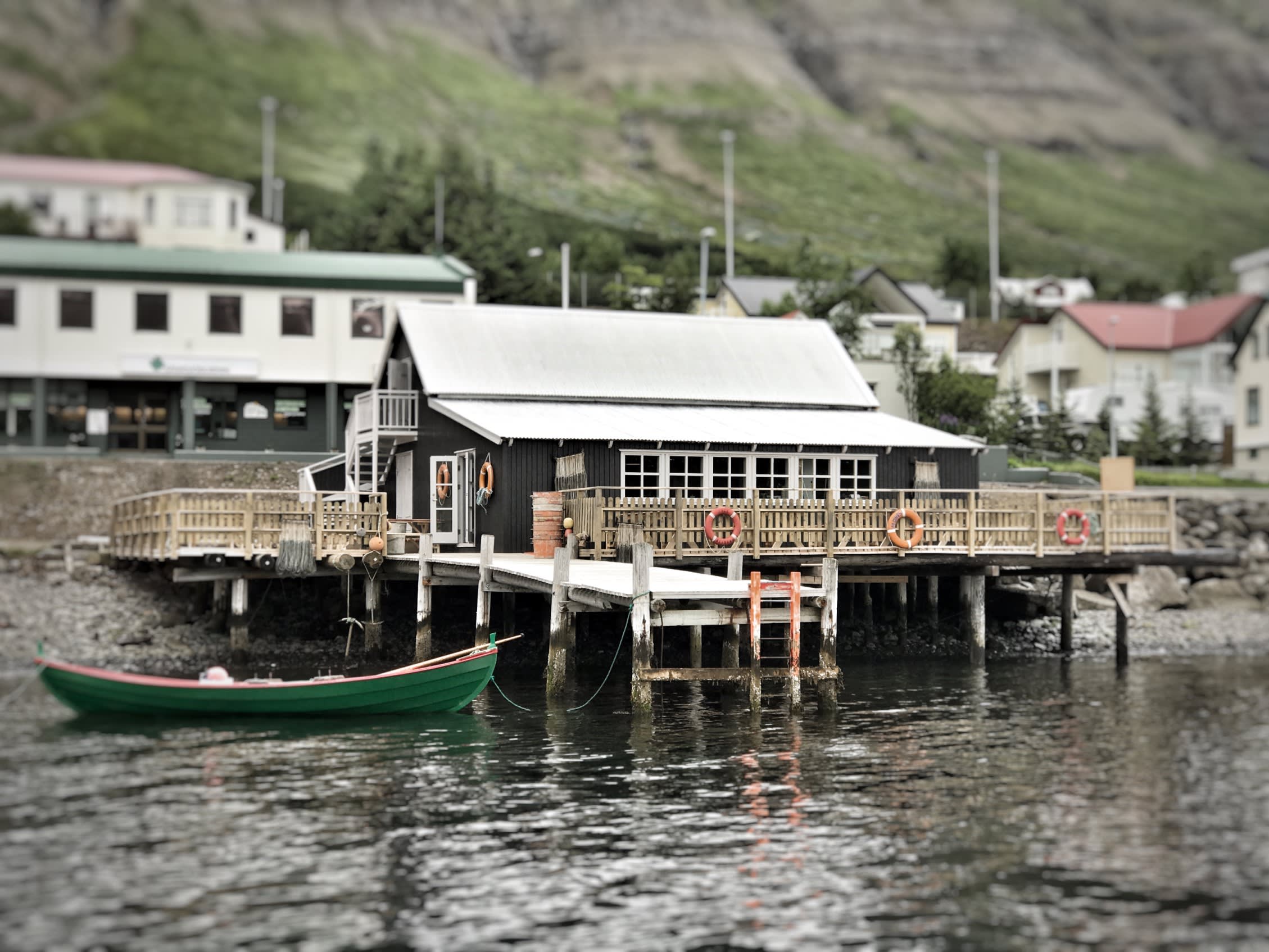 The Bait Shack, a black nautically decorated building, pictured here from the sea side