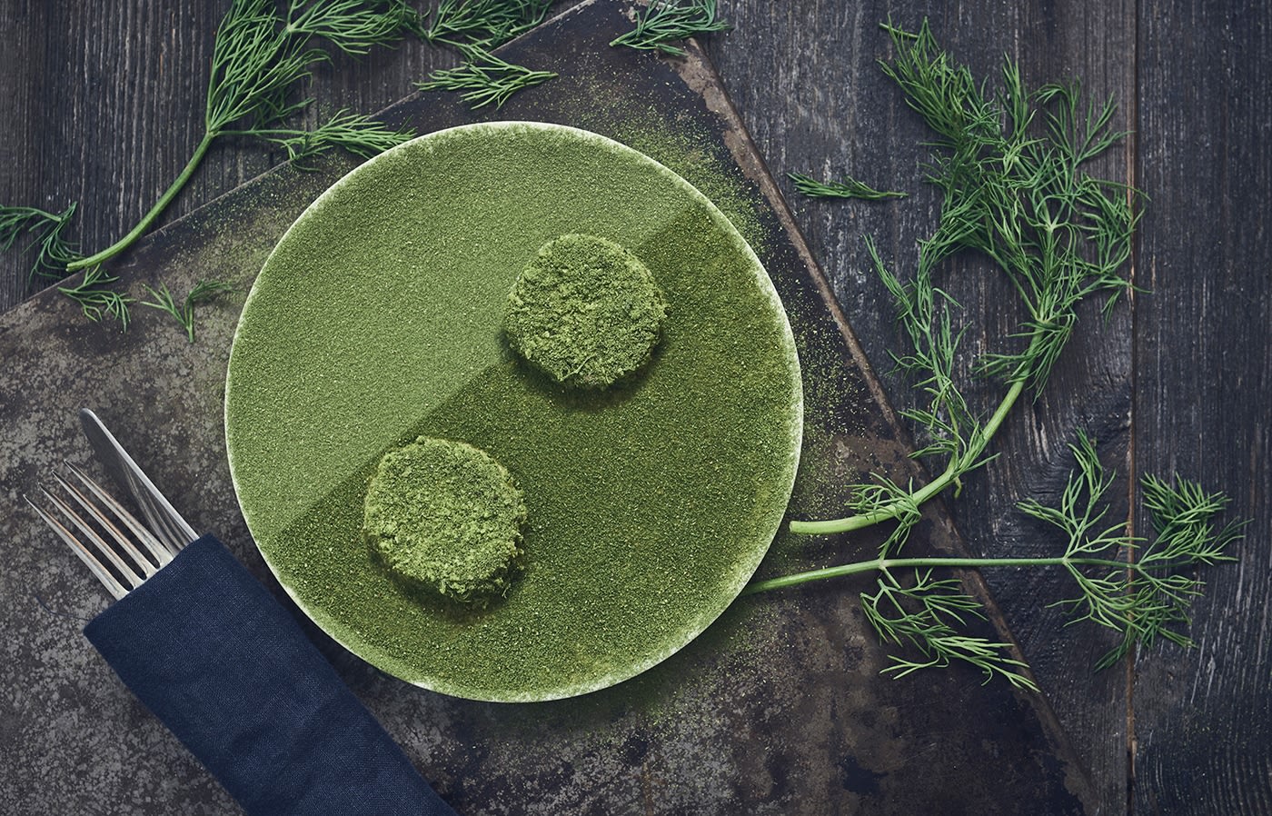 an overhead picture of a white plate covered in green herbs, served in Matur og drykkur restuarant