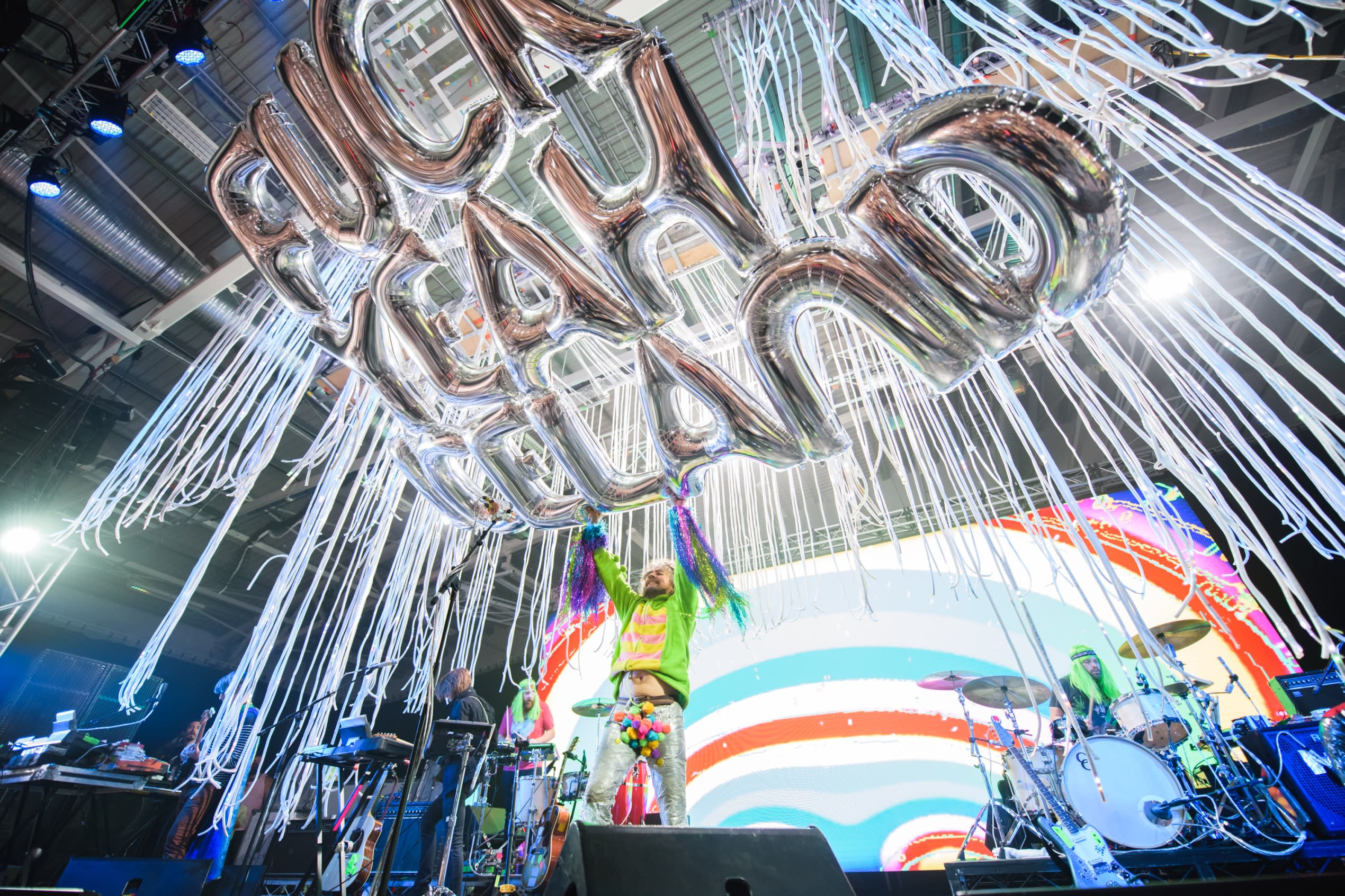 The Flaming Lips performer releases a large silver balloon that reads 'F*ck Yeah Iceland' into the crowd