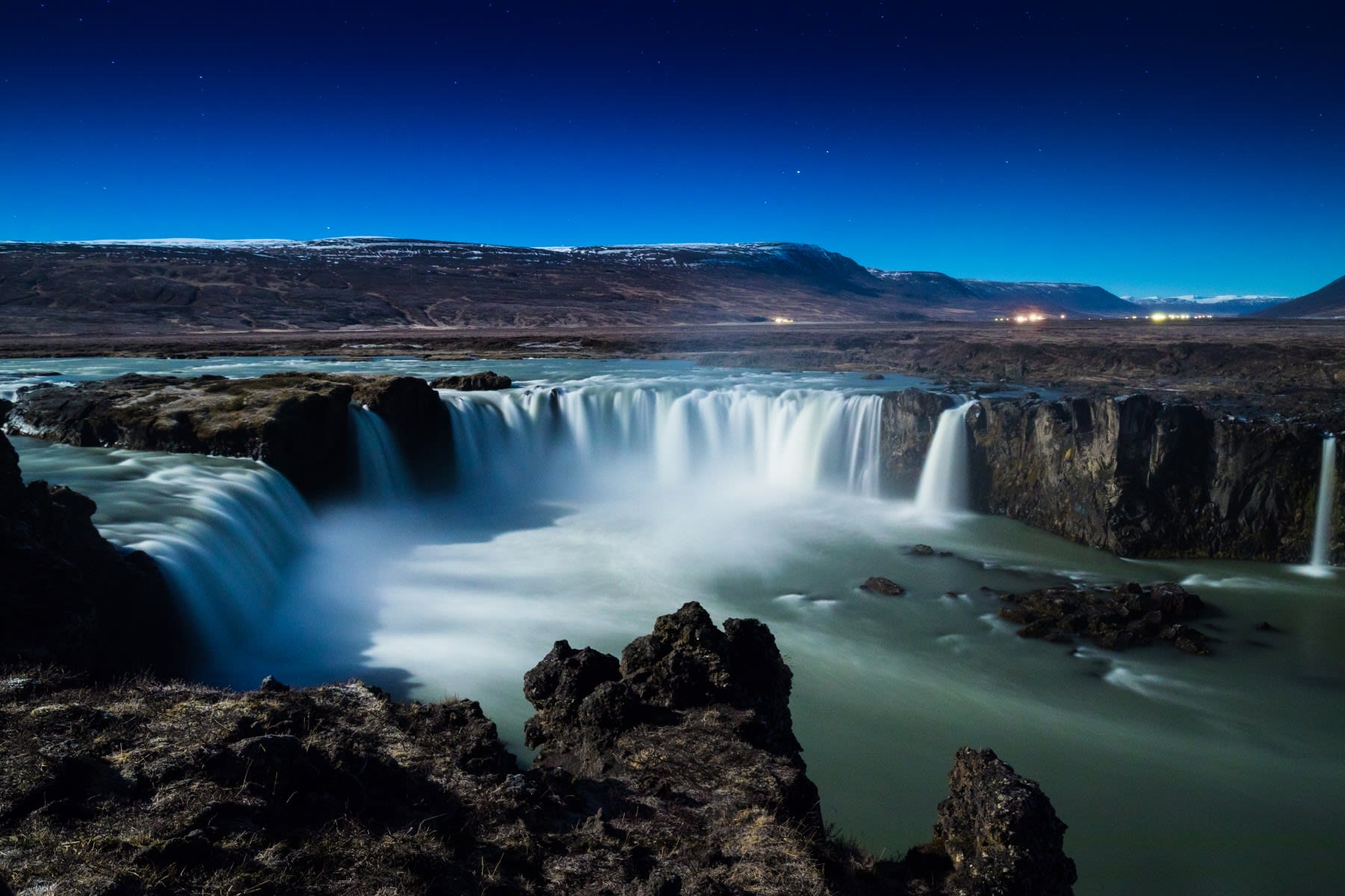 An image of Godafoss waterfall in North Iceland on a bright blue sky day