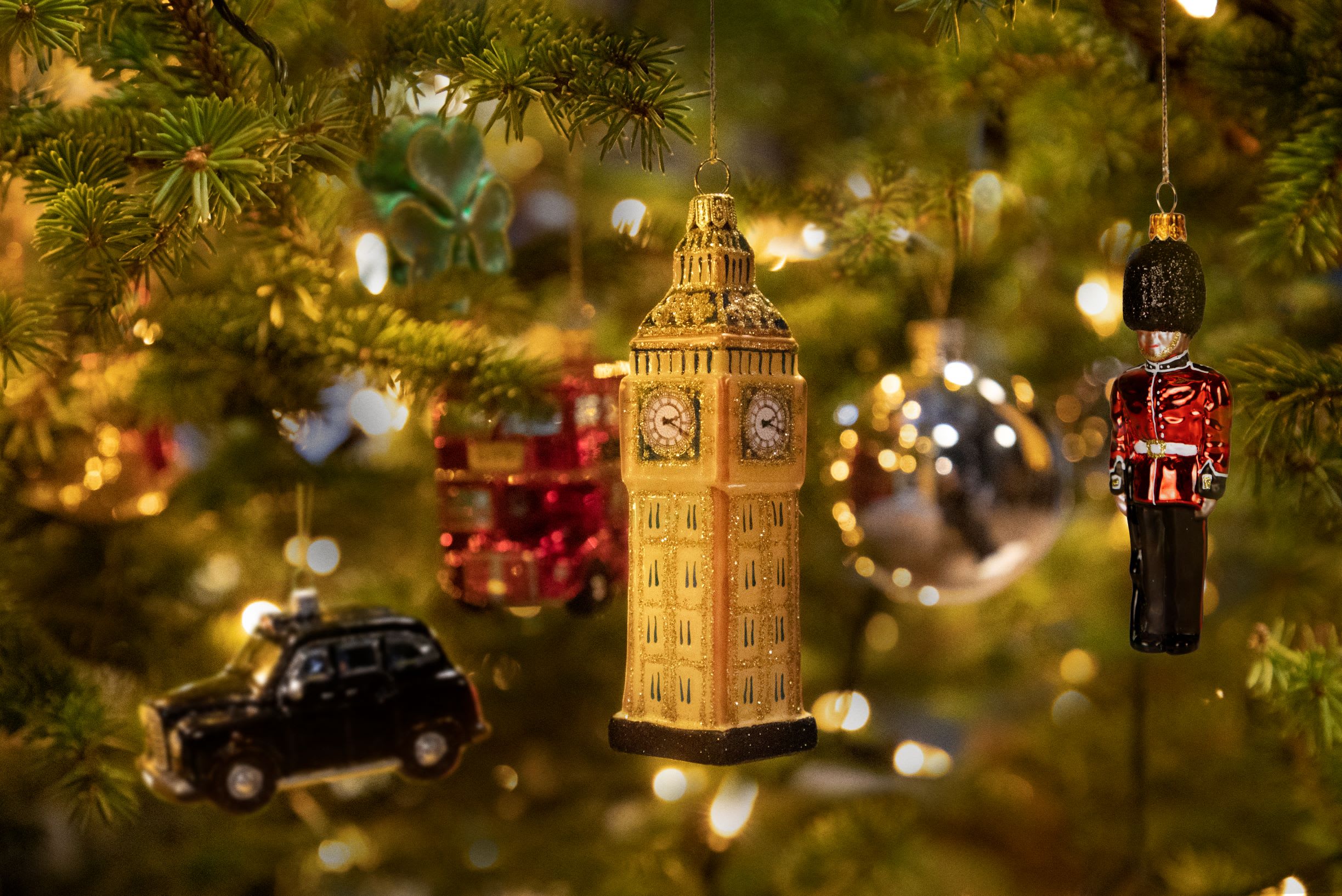 an up close Christmas tree with British themed decorations including Bi9g Ben, a black cab and a Queen's guard