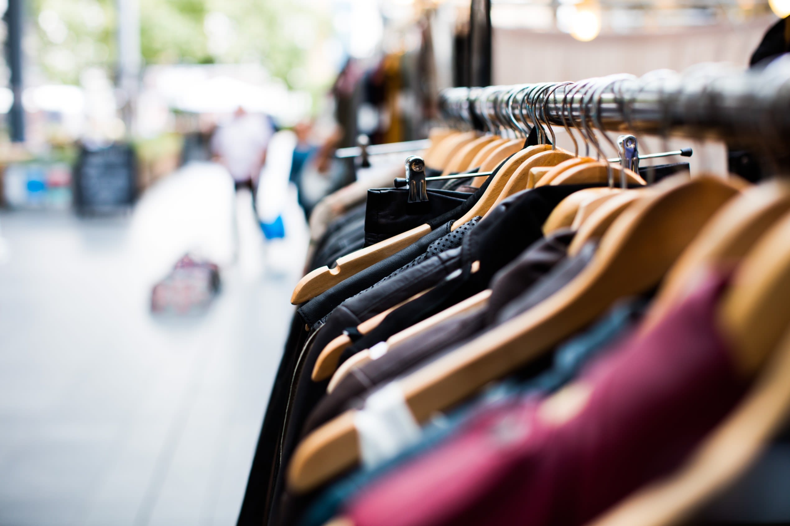 a clothing rail in a shop with lots of womens fashion items on it