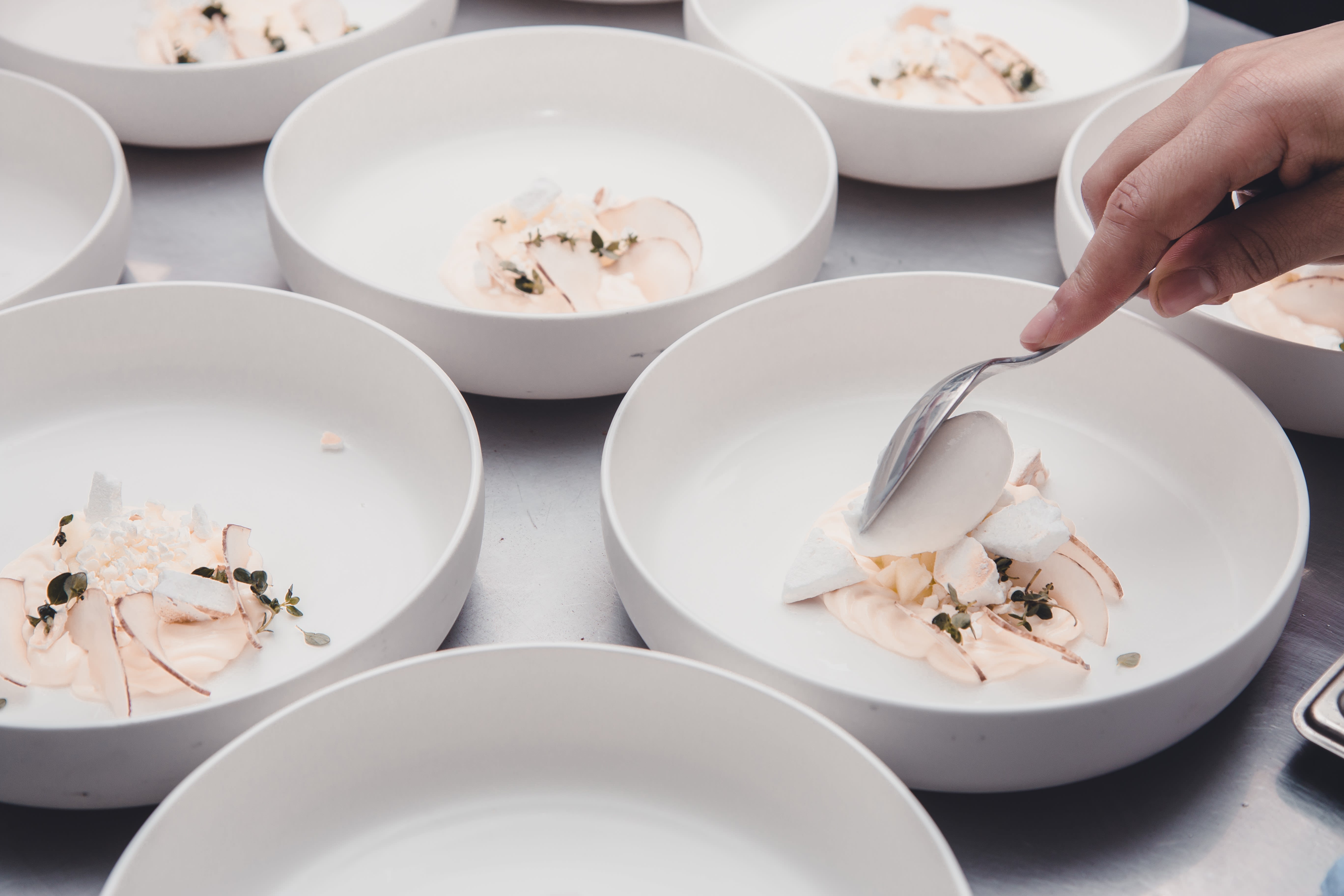 a collection of white bowl-like plates with a white and cream coloured dish in it