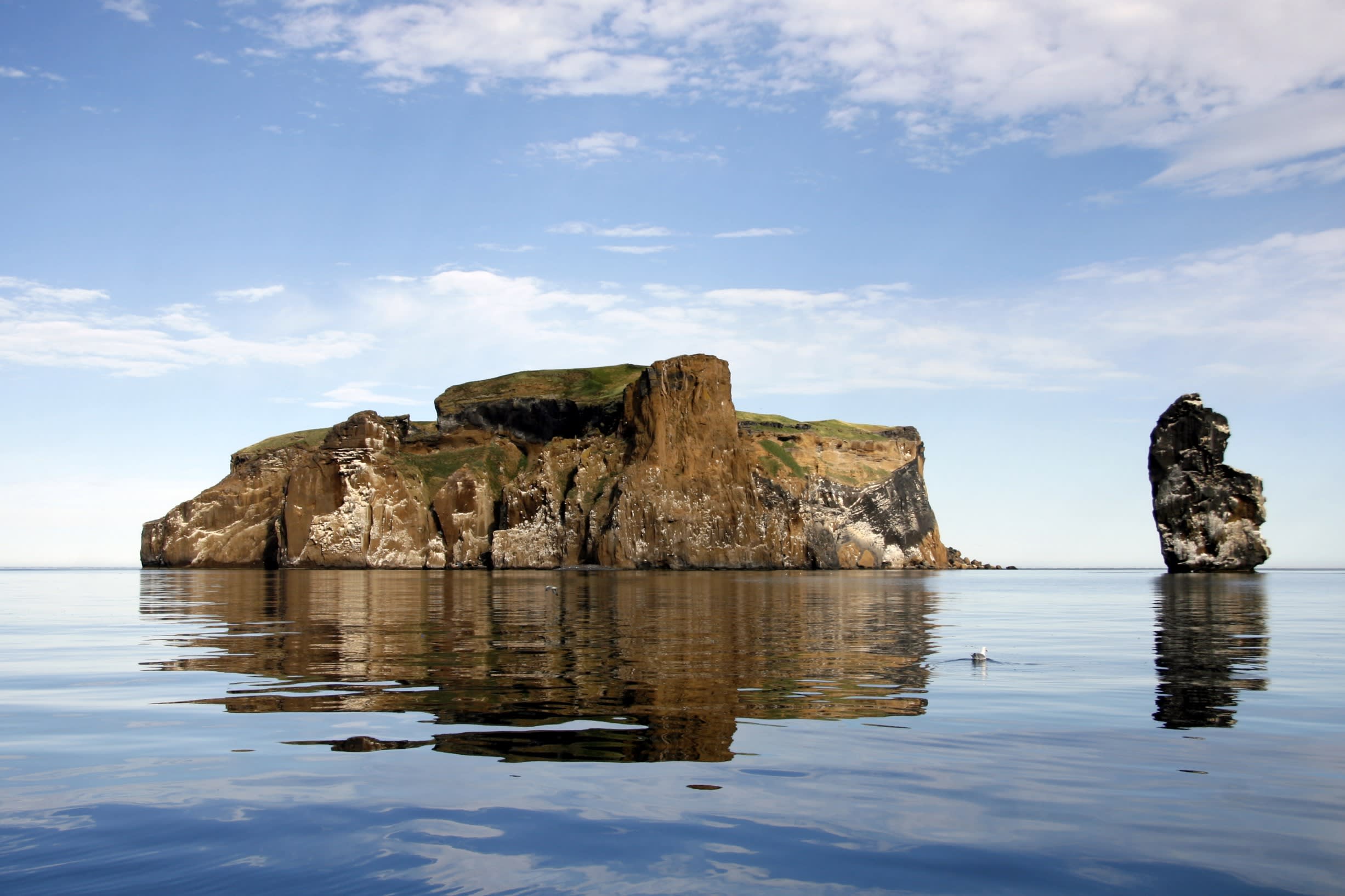 A rocky islet in Iceland called Drangey, pictured here on a bright summers day