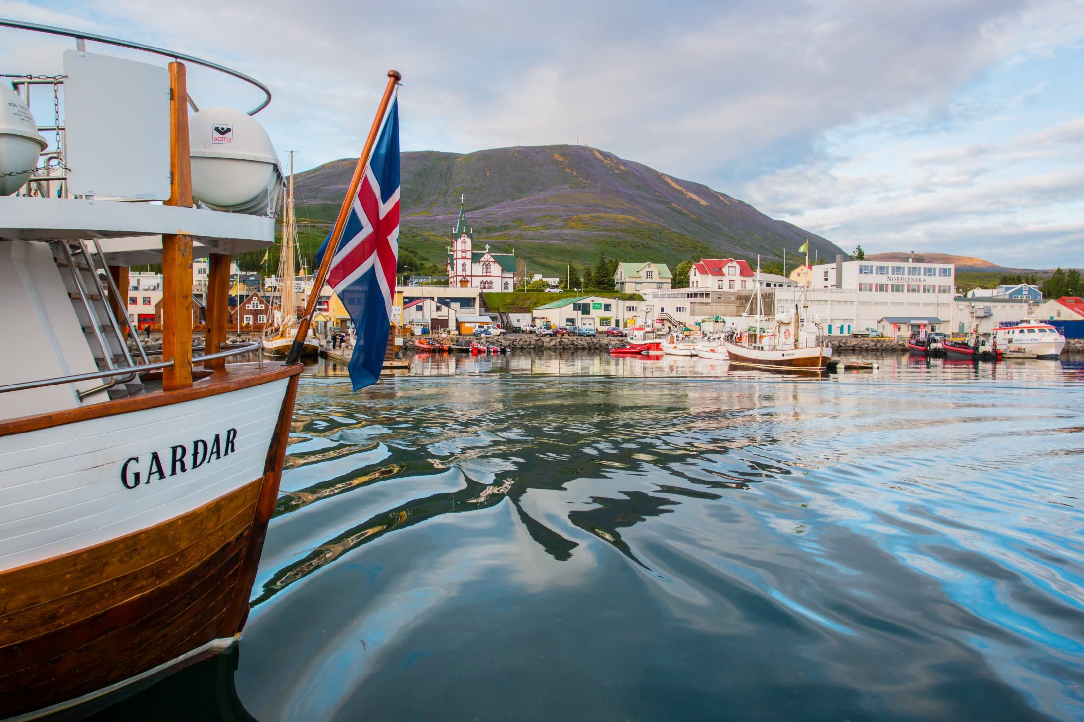 The harbour in Husavik, in North Iceland, viewed from out at sea on a boat