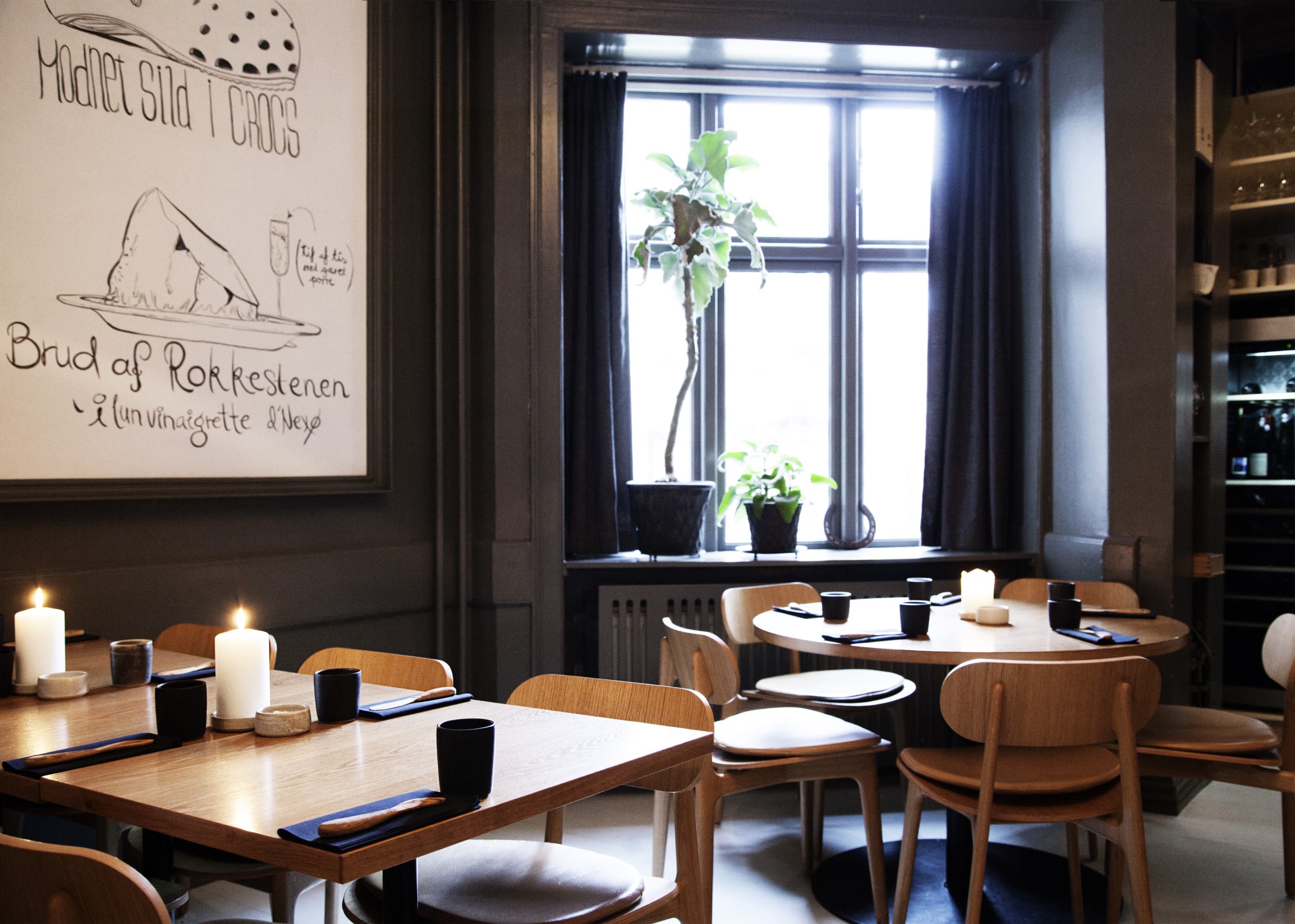 the interior of a restaurant called Pony, where tables are laid and the space designed in a very Nordic style