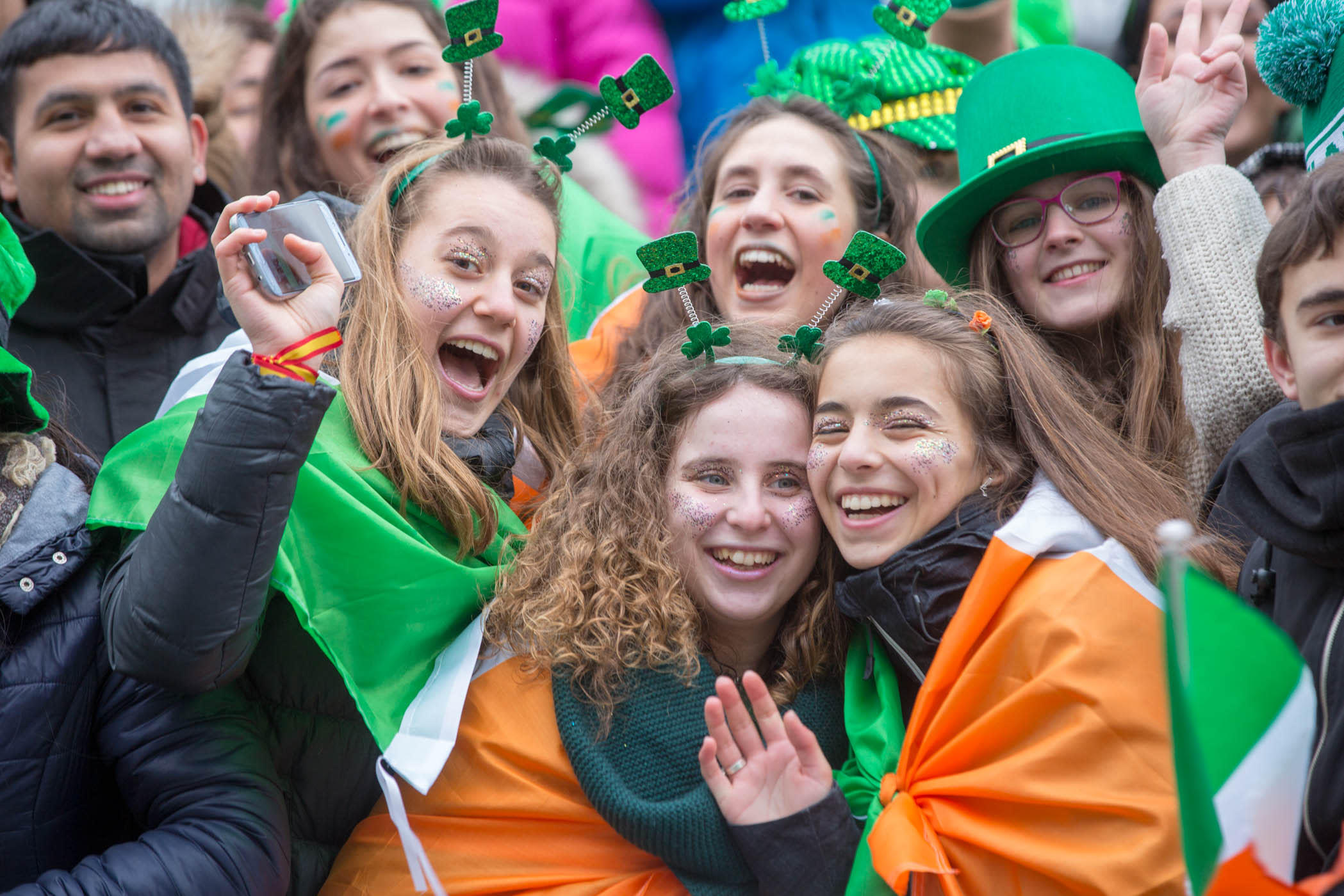 A group of young people celebrating St Patricks Day in Dublin, wearing lots of Irish themed memoriabilia