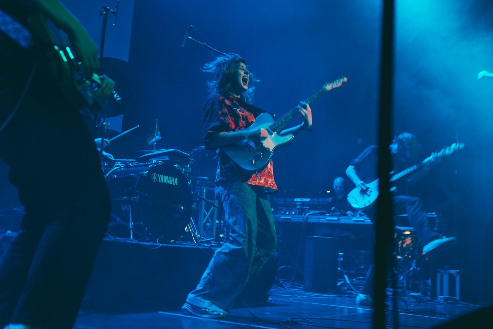 Musician Girl in Red performing with a band at Iceland Airwaves 2019, holding a guitar and looking excited