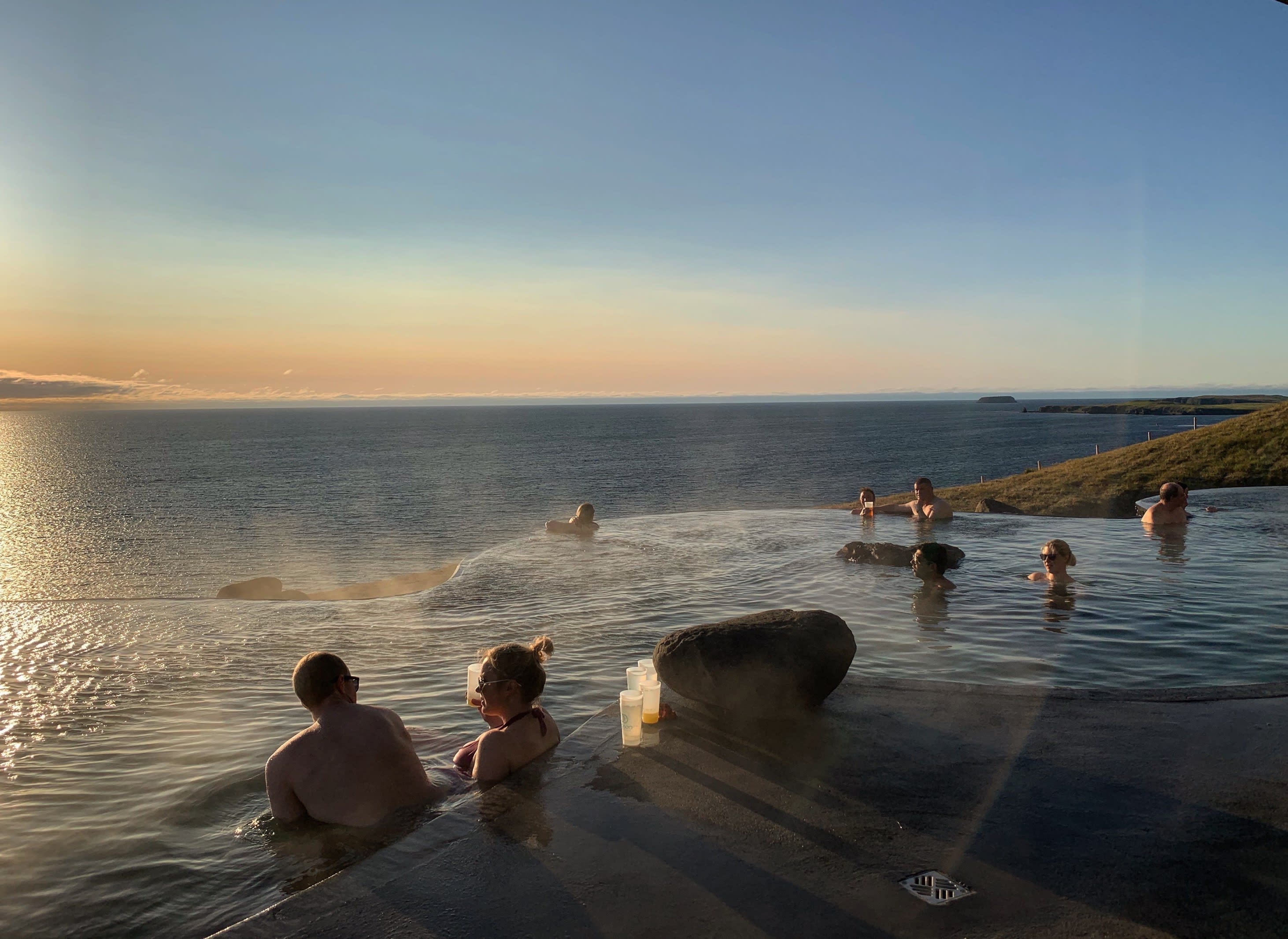 Couples gather in the warm pools at Geosea in Husavik at sunset