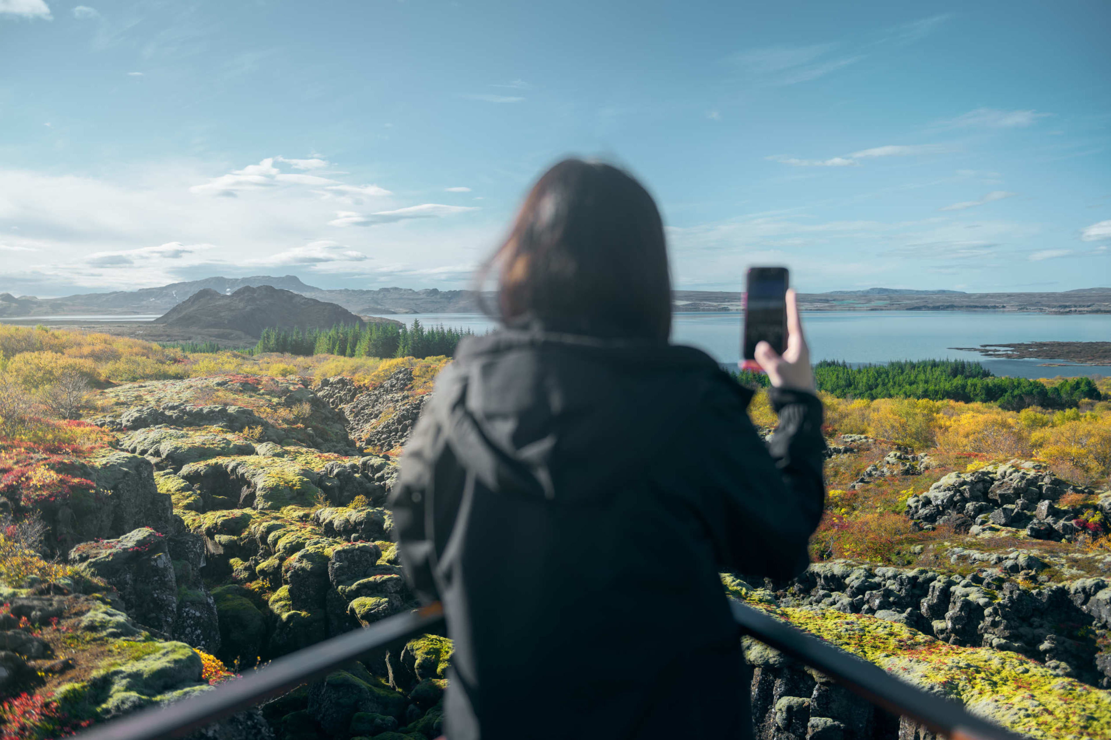 Woman taking picture at Thingvellir national park