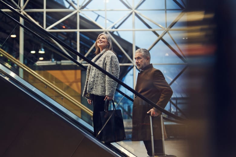 a couple heading up an escalator