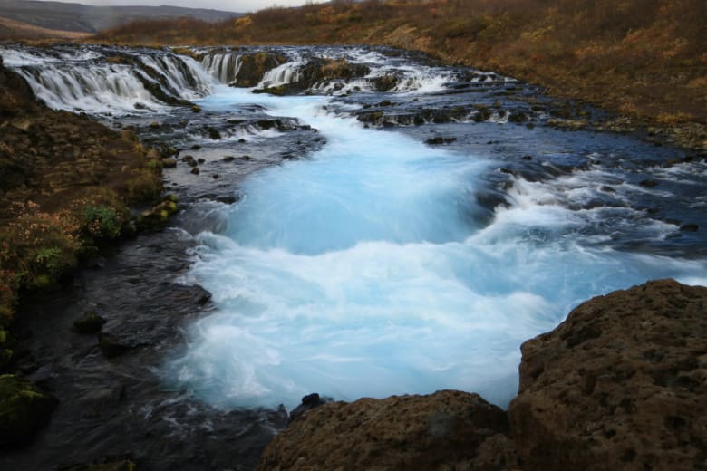 The clear blue waters of Brúarfoss waterfall
